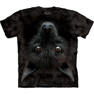 May include: Black t-shirt with a tie-dye pattern featuring a close-up image of a bat hanging upside down. The bat's eyes are visible, as well as its nose and ears.