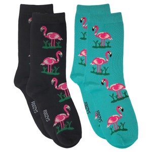 May include: A pair of socks with a flamingo print. One sock is black with pink flamingos and the other is turquoise with pink flamingos. The socks have the word "Foozys" written on them.