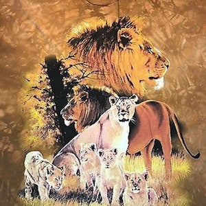 May include: A brown tie-dye t-shirt with a print of a pride of lions in a savanna setting. The lions are in various poses, including a large male lion with a mane, a female lion with cubs, and a group of cubs playing. The background is a brown and tan tie-dye pattern.