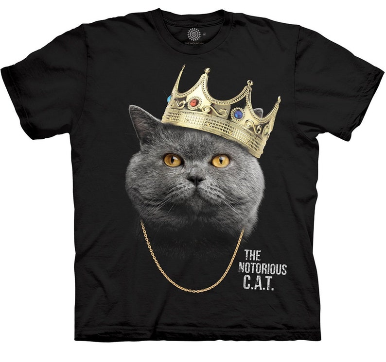 May include: Black t-shirt with a gray cat wearing a gold crown and a gold chain. The text "THE NOTORIOUS C.A.T." is printed on the shirt.