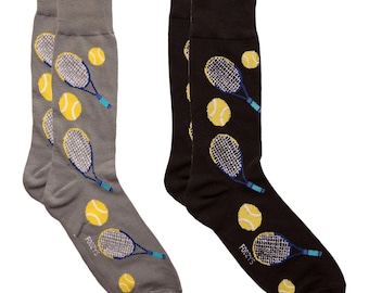May include: A pair of socks with a tennis theme. One sock is grey with yellow tennis balls and blue tennis rackets. The other sock is black with yellow tennis balls and blue tennis rackets. The socks have the word "FOXY" printed on the bottom.