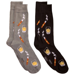May include: Two pairs of crew socks, one gray and one black, with a repeating pattern of cigars, whiskey glasses, and smoke. The socks have the word "FOOZYS" printed on the sole.