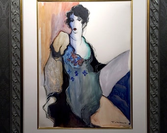 May include: An abstract watercolor painting of a woman in a blue dress with floral accents, framed in a decorative gray frame. The artwork features a black jacket and a light background. The frame has a gold inner edge.