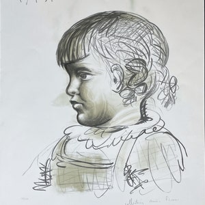 May include: A charcoal sketch of a young child in profile, with detailed shading and line work. The artwork features the date "15.1.51" at the top and the text "collection Marie Picasso" at the bottom. The child's hair is styled with bangs and curls.
