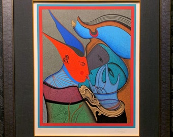 May include: Framed abstract art print featuring figures in shades of red, blue, green, and gold. The artwork has a geometric style with a red border and a black frame. The print is signed in the lower right corner.