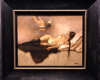 May include: Oil painting in a black frame with a gold inner edge. The artwork depicts a nude figure reclining on a bed, with an angel hovering above. The painting has a warm, muted color palette and is signed in the lower right corner.