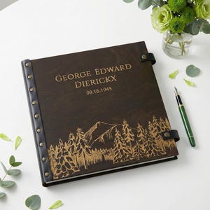 Custom engraved wooden memory Photo album designed as a family legacy album. The dark brown wood cover features a rustic pine tree design and personalized text, making it a meaningful keepsake for family history and old photos.