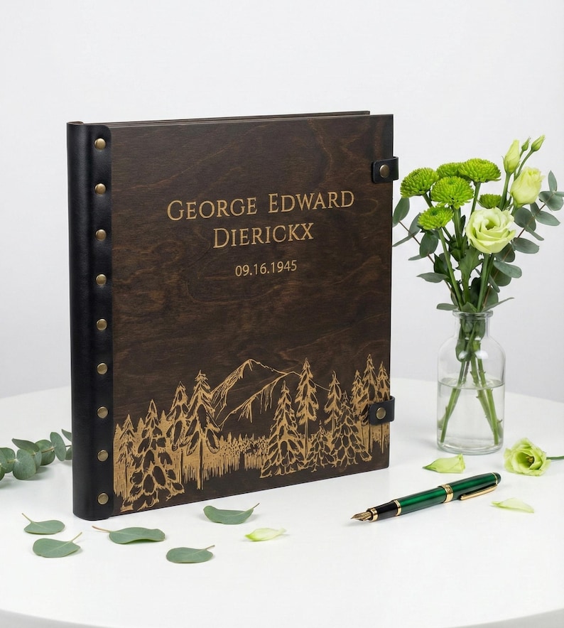Personalized wooden Photo album perfect for a milestone birthday or retirement gift. The dark wood cover shows a custom engraved name, a 1945 birth year, and a nature-inspired mountain scene.