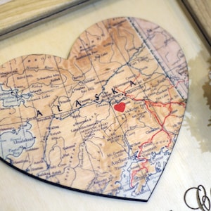 Custom map heart gift for long-distance relationships. Detail view of a personalized Alaska map with a red heart marking a special place. A sentimental 5th-anniversary wood gift or 'where we met' keepsake for couples.