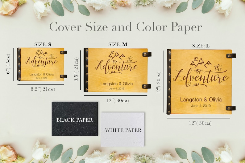 A product infographic titled "Cover Size and Color Paper" showcasing three sizes of personalized wooden photo albums against a floral background. Size Small is 6 by 8.5 inches (15x21cm); Size Medium is 8.5 by 12 inches (21x30cm); and Size Large is 12 by 12 inches (30x30cm). Below the albums, two paper color options are shown: textured black paper and textured white paper. Each album features a laser-engraved floral design with the names "Teddi & Neill" and a date.