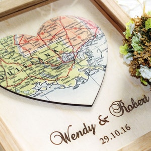 Personalized Louisiana state map gift. Wooden framed art featuring a heart-shaped map of Louisiana including New Orleans and Baton Rouge. Laser engraved with 'Wendy & Robert' and wedding date. Custom southern home decor and keepsake.