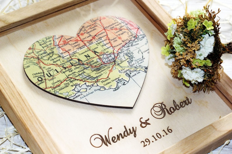 Personalized Louisiana state map gift. Wooden framed art featuring a heart-shaped map of Louisiana including New Orleans and Baton Rouge. Laser engraved with 'Wendy & Robert' and wedding date. Custom southern home decor and keepsake.
