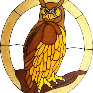 May include: Stained glass owl artwork. The owl is brown with yellow and gray accents, perched on a brown branch. The artwork is framed by a gold-colored circle. The text "ALI'S CRAFT STUDIO : STUDIOCRAFTS.NET" is at the bottom.