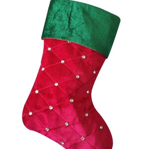 May include: A red velvet Christmas stocking with a green velvet cuff and silver glitter accents.