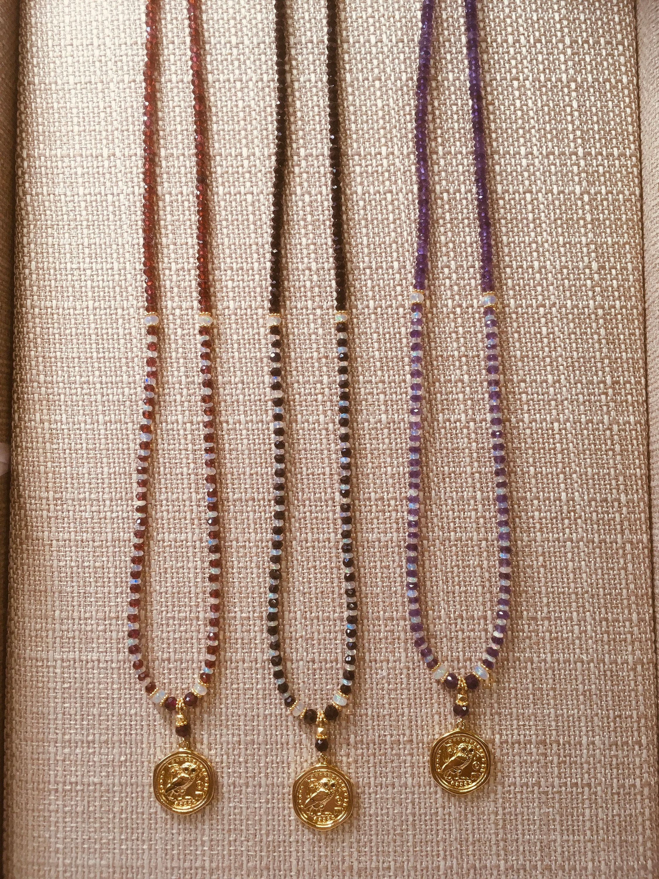 Greek Athena owl pendant on Ethiopian opal and various gemstone bead necklaces