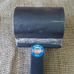 May include: A black metal pipe bender with a welded handle. The bender has a sticker that says "Made in Montana USA".
