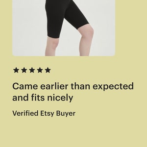 May include: A woman wearing black biker shorts and a white sports bra.