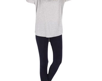 May include: A gray long-sleeved shirt with a relaxed fit and a pair of dark blue leggings.