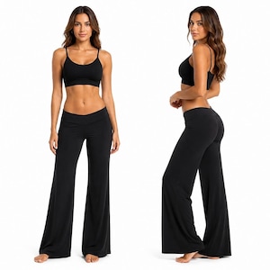 May include: A black two-piece set consisting of a scoop-neck sports bra with thin shoulder straps and matching high-waisted wide-leg pants. The outfit is shown from both a front-facing view and a side-profile view against a plain white background.