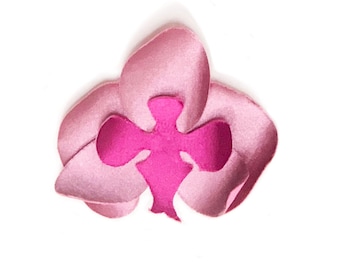 May include: A pink felt orchid flower with a magenta center. The flower is made of felt and has a realistic appearance.
