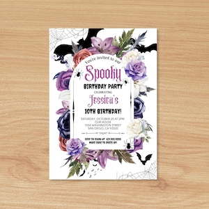 May include: A purple, white, and black Halloween birthday party invitation with a spooky theme. The invitation features a floral arrangement with bats, spiders, and a spider web. The text reads "You're invited to our Spooky Birthday Party Celebrating Jessica's 10th Birthday! Saturday, October 25 at 2PM Our House 5154 Washington Street San Diego, CA 92020 RSVP to [phone number] Make sure to dress up!"