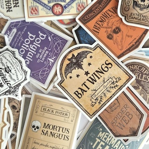 May include: A collection of vintage-style stickers with various designs. The stickers feature labels with text like "Bat Wings," "Black Potion," and "Polyjuice Potion." The color palette includes shades of brown, purple, and cream, with illustrations of bats, skulls, and other gothic elements.