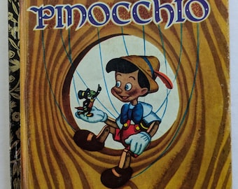 May include: A vintage Little Golden Book cover featuring a cartoon image of Pinocchio, a wooden puppet, with Jiminy Cricket on his shoulder. The book is titled "Walt Disney's Pinocchio" and has a yellow and brown background.