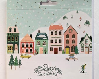 May include: A package of stickers featuring a winter village scene with colorful houses, trees, and skiers. The text "Busy Sidewalks" is displayed below the illustration, along with the number "293" and the words "Stickers | Autocollants | Pegatinas".