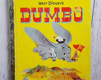 May include: A vintage Little Golden Book featuring Walt Disney's Dumbo. The cover shows Dumbo flying with a mouse holding a flag that says "D". The book is yellow with red and black text. The price tag says "Coles 99¢".