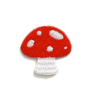 May include: Embroidered patch of a red mushroom with white spots and a white stem. The patch is intricately stitched, giving it a textured look. Suitable for embellishing clothing or accessories. A charming, decorative item.