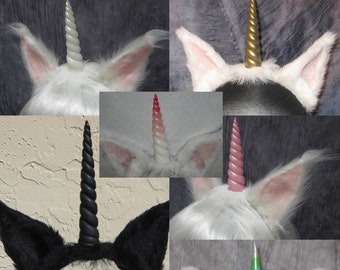 May include: A collection of unicorn headbands featuring faux fur ears in white or black. The horns are spiraled and come in various colors including white, gold, black, pink, and a red-to-white gradient. Each headband displays a single horn.