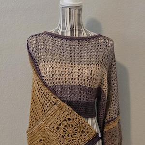 May include: A long-sleeved crochet top featuring a horizontal striped pattern in shades of brown, tan, and purple. The garment incorporates an open-work mesh stitch throughout the body and sleeves, with a prominent square motif panel in brown.