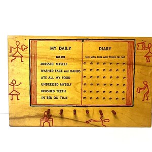 May include: Wooden daily diary board with red text and illustrations. The board is divided into two sections: "My Daily" and "Diary." The "My Daily" section lists tasks like "Dressed Myself" and "Brushed Teeth." The "Diary" section has holes for tracking daily activities.