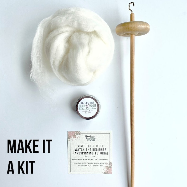 May include: A hand spinning kit with a wooden spindle, a small tin of fiber prep, and a ball of white wool. The card reads "Make it a kit" and "Visit the site to watch the beginner handspinning tutorial www.fiberculture.co/tutorials".