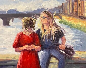 May include: Two people are sitting on a stone wall overlooking a river. The person on the left is wearing a red dress and the person on the right is wearing blue jeans and a black shirt. The river is in the background and there is a bridge in the distance.