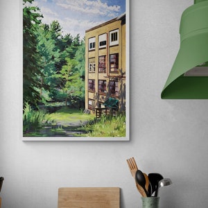 May include: A framed painting of a yellow building with multiple windows, set against a backdrop of lush green trees and a blue sky with white clouds. The building appears to be an old factory or mill.