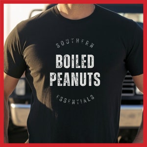 May include: Black t-shirt with white text that reads "Southern Boiled Peanuts Essentials".