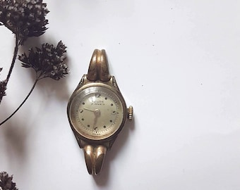 Vintage Relide montre poignet bracelet femme mécanique ancienne horlogerie bijouterie Suisse années 30 couleur dorée bijou rénovation