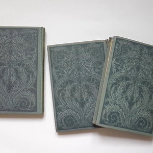 May include: Three vintage hardback books with green covers and intricate floral designs. The books are arranged in a row, with the spines facing the viewer.