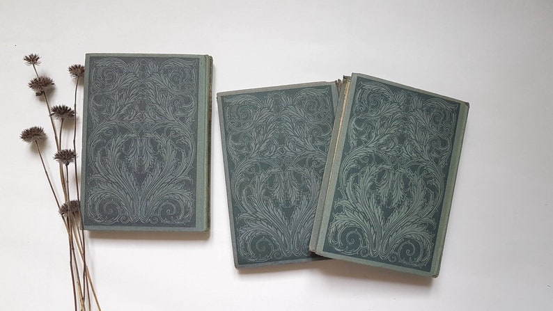 May include: Three vintage hardback books with green covers and intricate floral designs. The books are arranged in a row, with the spines facing the viewer.