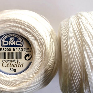 May include: A 2 ball pack of white DMC Cebélia crochet thread, size No 30, 50g each. The label features the text Creative World, DMC, B5200, No 30, made in France, Lot 18363, and Cebélia. The image also includes the text 2 ball pack and pack 8 cebelia No 30 50 g.