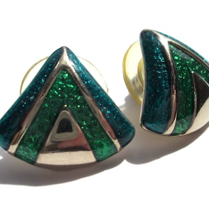 May include: A pair of silver tone earrings with a geometric design. The earrings are green and blue with a sparkly finish.