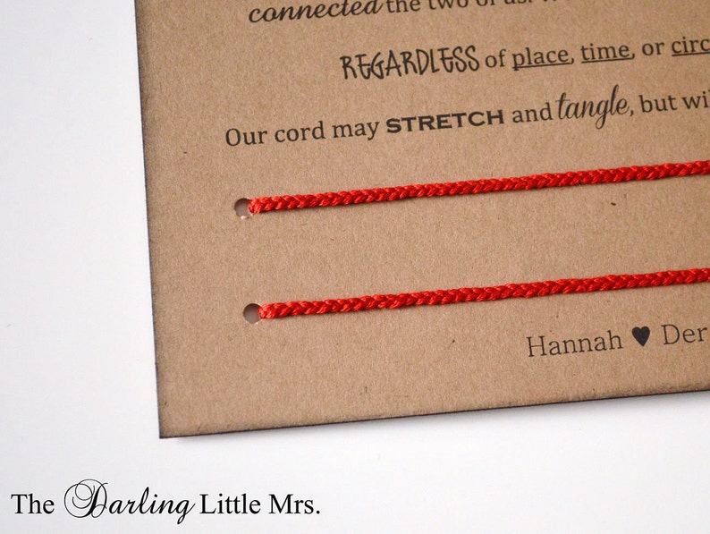 May include: A close-up of a brown card with two red cords threaded through holes. Text on the card reads "REGARDLESS of place, time, or circle" and "Our cord may STRETCH and tangle, but will". The Darling Little Mrs. is printed at the bottom.