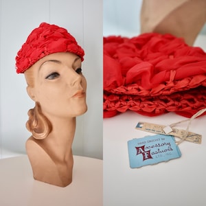 May include: A red crocheted hat with a label that reads "HAND CROCHET by Accessory Fashions LTD., INC."