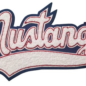 May include: White felt "Mustangs" lettering with red outline on a blue felt background. The lettering is in a cursive font and is arched.