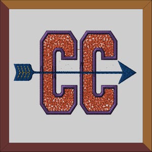 May include: An embroidered patch featuring the letters "CC" in orange with purple outlines. An arrow with a blue shaft and gold fletching points to the right, passing through the centre of the letters.