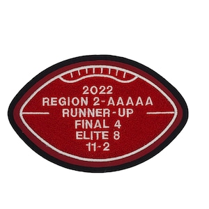May include: Red and white football-shaped patch with the text "2022 Region 2-AAAAAA Runner-Up Final 4 Elite 8 11-2"