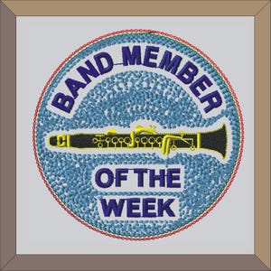 May include: A blue and yellow embroidered patch with a clarinet and the text "Band Member of the Week".