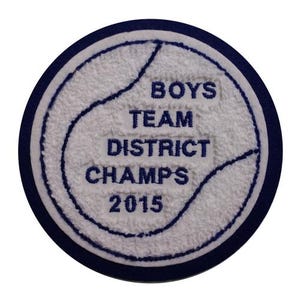 May include: White embroidered patch with a blue border. The patch features a baseball with the text "Boys Team District Champs 2015".