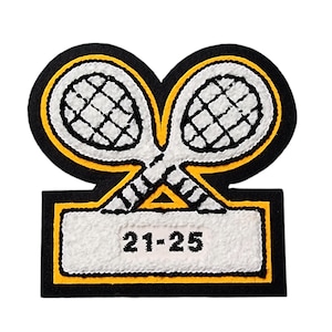May include: A tennis-themed patch with two crossed tennis rackets in white, outlined in yellow, and set against a black background. The patch includes a rectangular section with the numbers "21-25" in black.